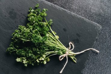 A bunch of parsley on a cutting board